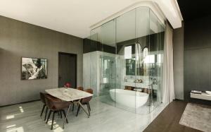 a bathroom with a tub and a table and a sink at Alexander, Member of The Leading Hotels of the World in Mexico City +20 photos