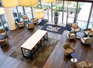 an overhead view of a lobby with chairs and tables at The Whitehall Houston in Houston