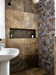 a bathroom with a sink and a shower at Casa Roma in Taxco de Alarcón +60 photos