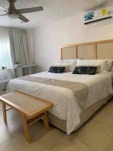 a bedroom with a large bed with a wooden headboard at Beautiful house with a pool in Mérida