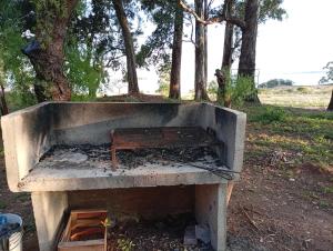 a concrete oven with a bench sitting in it at Finca Re Mar 1 in Santa Ana