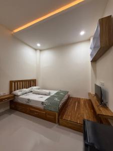 a bedroom with a bed and a flat screen tv at Salt & Light Labuan Bajo in Komodo Labuan Bajo Airport