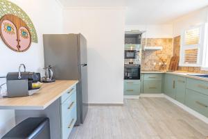 a kitchen with blue cabinets and a refrigerator at Pointe Noire in Pointe-Noire
