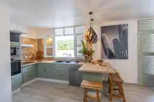 a kitchen with blue cabinets and a table with chairs at Pointe Noire in Pointe-Noire