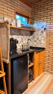 a kitchen with a stove and a counter top at Doce inga in Cairu