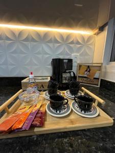 a table with four pots and pans and a coffee maker at Laranjeiras House in Uberaba +32 photos