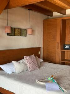 a bedroom with a bed with two pendant lights at Monterra Tapalpa in Tapalpa