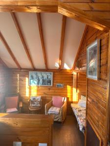 an attic room with wooden walls and wooden ceilings at Casa Almar in Algarrobo