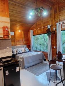 a bedroom with a bed and a couch in a room at Cabana Zanetti in Santa Teresa