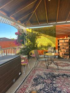 a patio with a table and chairs and a brick wall at Casa Almar in Algarrobo