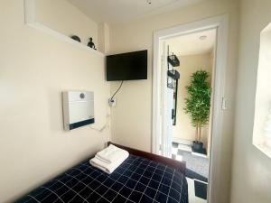 a room with a bed with a blue tiled floor at 7A - A Diamond in Yonkers in Yonkers