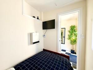 a bedroom with a bed with blue tiles on the floor at 7A - A Diamond in Yonkers in Yonkers