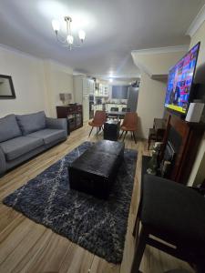 a living room with a couch and a tv at Gracian OMB Ongar 3 Bed in Dublin +13 photos
