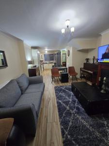 a living room with a couch and a piano at Gracian OMB Ongar 3 Bed in Dublin