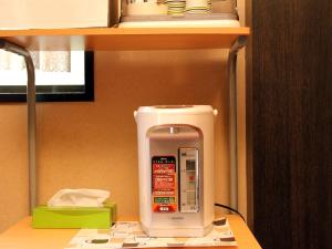 a white appliance sitting on top of a shelf at Hotel Sankyu in Tsukuba +19 photos