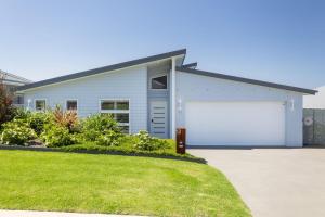 a white house with a large garage at Casa Azul in Burrill Lake