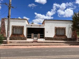 a white house on the side of a street at Casa Chule in Fiambalá +3 photos