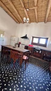 a dining room with a wooden table and chairs at Casa Chule in Fiambalá