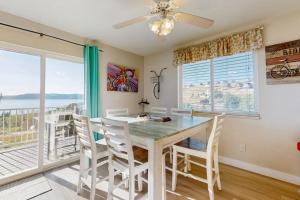 a dining room with a table and chairs and a balcony at Bear Lake View in Garden City