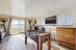 a room with a foosball table and a bedroom at Bear Lake View in Garden City