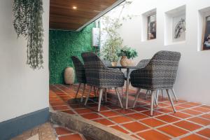 a patio with a table and chairs on a tile floor at Tefos room in Quito +8 photos