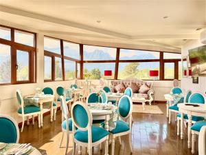 a dining room with tables and chairs and windows at Martina de Goñi in Pucón