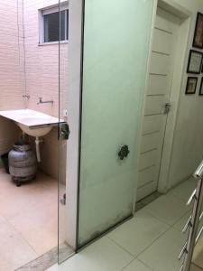 a glass shower door in a bathroom with a sink at Casa Central in São Raimundo Nonato +15 photos
