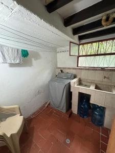 a bathroom with a sink and a washing machine at Hospedaje Casa Renasiente Cali in Cali