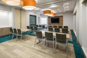 a conference room with a long table and chairs at EVEN Hotel Rockville - Washington, DC Area by IHG in Rockville