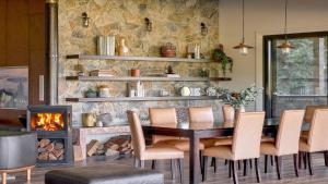 a dining room with a table and a fireplace at Grants - West Cambewarra, Longreach in West Cambewarra