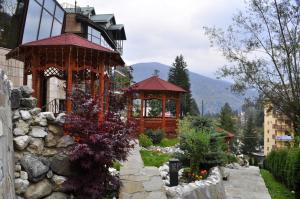 a building with a gazebo in a garden at Hotel Arca lui Noe in Sinaia