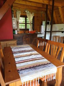a kitchen with a wooden table with a rug on it at Complejo El Tala in Villa la Bolsa