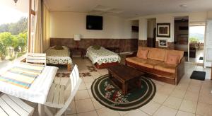 a living room with a couch and a table at Miravalle Suites in Paipa
