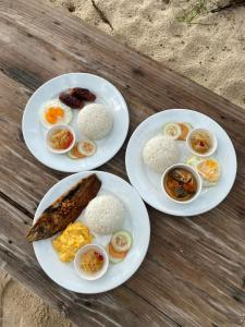 three plates of eggs and rice on a wooden table at Castle Rock Boracay in Boracay +28 photos