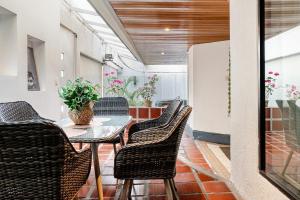 a dining room with a table and chairs at Lili’s room in Quito