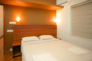 a bed in a room with two white pillows at Cloud 9 Homestay, Thekkady in Thekkady