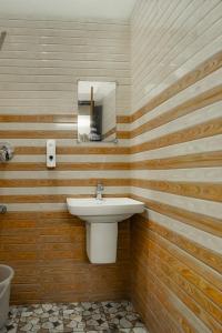 a bathroom with a sink and a mirror at Cloud 9 Homestay, Thekkady in Thekkady +22 photos