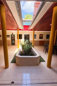 a lobby with a planter in the middle of a building at Casa del Jaguar in Iquitos +5 photos