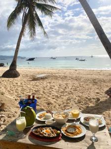 a table with food and drinks on the beach at Castle Rock Boracay in Boracay