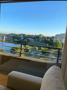 a room with a window with a view of a city at Acogedor departamento in Concepción
