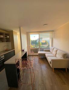 a living room with a couch and a table at Acogedor departamento in Concepción