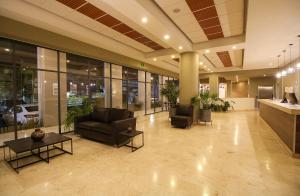 a lobby with chairs and tables in a building at Hotel Turotel Morelia in Morelia +39 photos