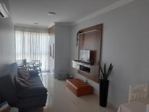 a living room with a couch and a table at Ap 503 Ed Brisa do sol em Piratuba in Piratuba
