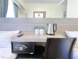 a desk in a hotel room with a computer on it at Red Planet Cebu in Cebu City