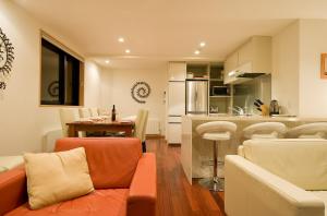 a kitchen and living room with a couch and a table at Cecuko A in Kutchan +5 photos