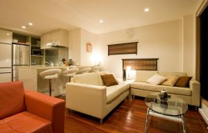 a living room with a couch and a table at Cecuko A in Kutchan