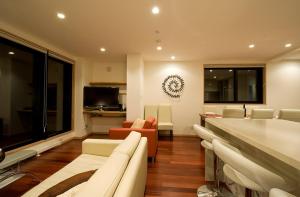 a living room with a couch and a table at Cecuko A in Kutchan