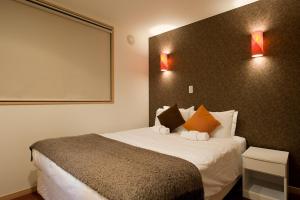 a bedroom with a large bed with a large screen at Cecuko A in Kutchan