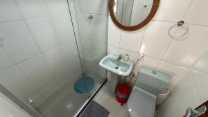 a bathroom with a shower and a toilet and a sink at Caminho de Itacoatiara in Niterói