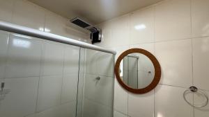 a bathroom with a mirror and a shower at Caminho de Itacoatiara in Niterói